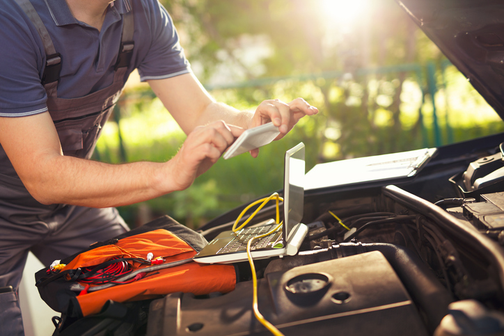 Professional car mechanic using smartphone app